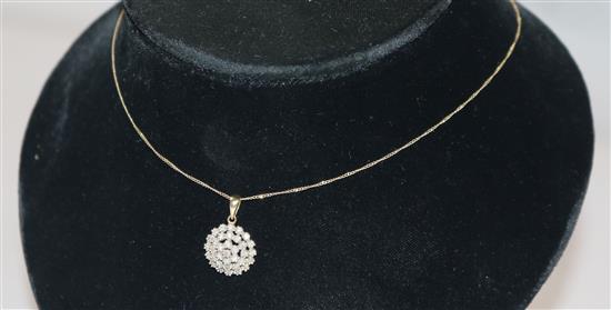 A 9ct gold and diamond set cluster pendant on a 9ct gold chain, pendant 15mm.